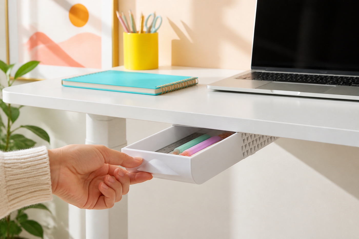 White DeskNook adhesive drawer opened by hand beneath a bright desk