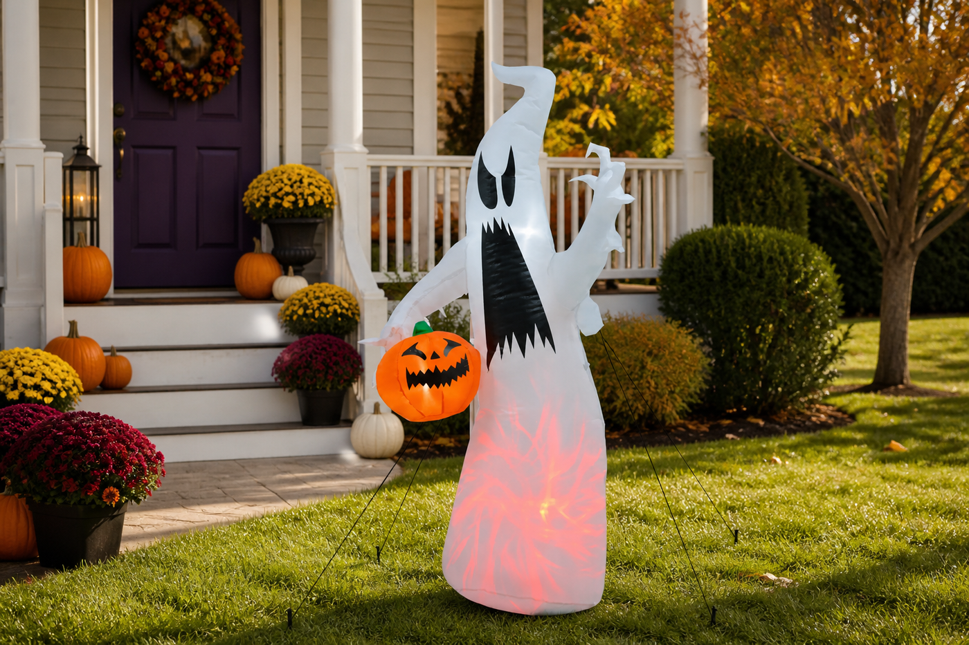 WraithGlow Halloween ghost inflatable secured with ground stakes and drawstrings on a front lawn