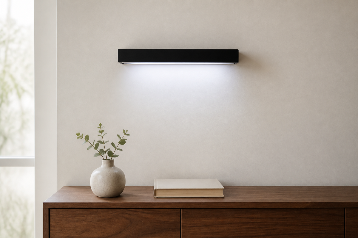 Halo LED Floating Shelf casting a clean pool of light above a walnut living-room console