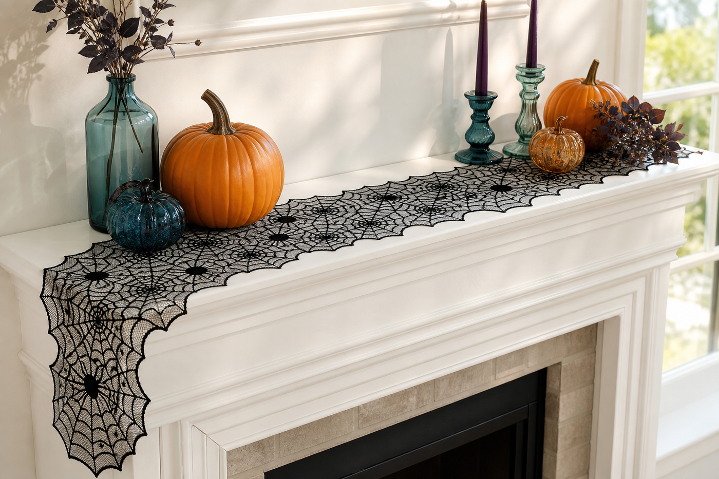 Webveil black spiderweb lace runner used across a bright white mantel with colorful reusable Halloween accents