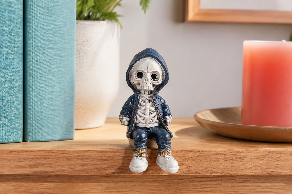 Navy C ShelfBones seated skeleton figurine on a warm wood shelf
