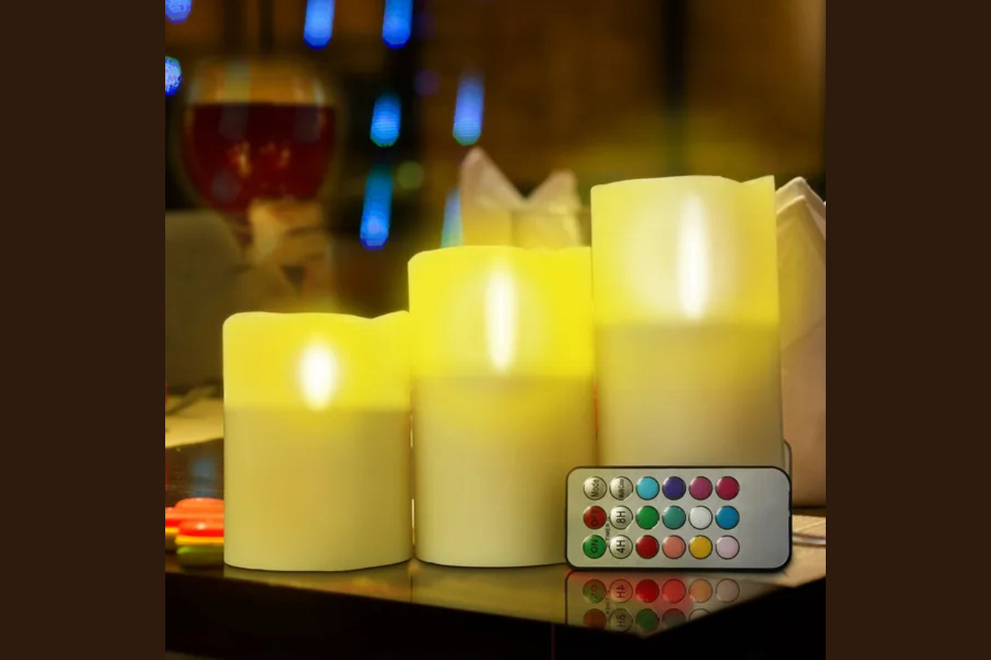 Exact Vesper three-candle arrangement glowing in warm mode with the remote