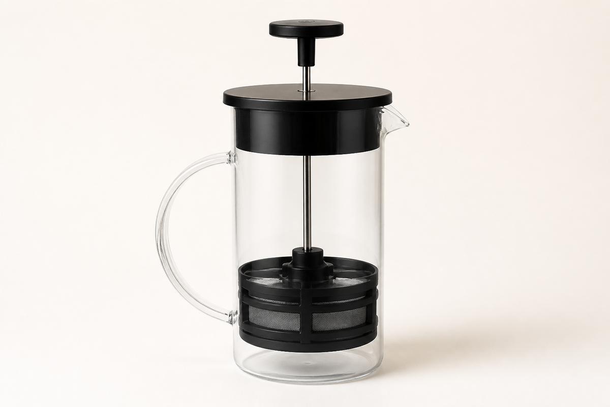 Empty Steep 1000 ml glass tea press with black lid, plunger and mesh filter on an ivory background