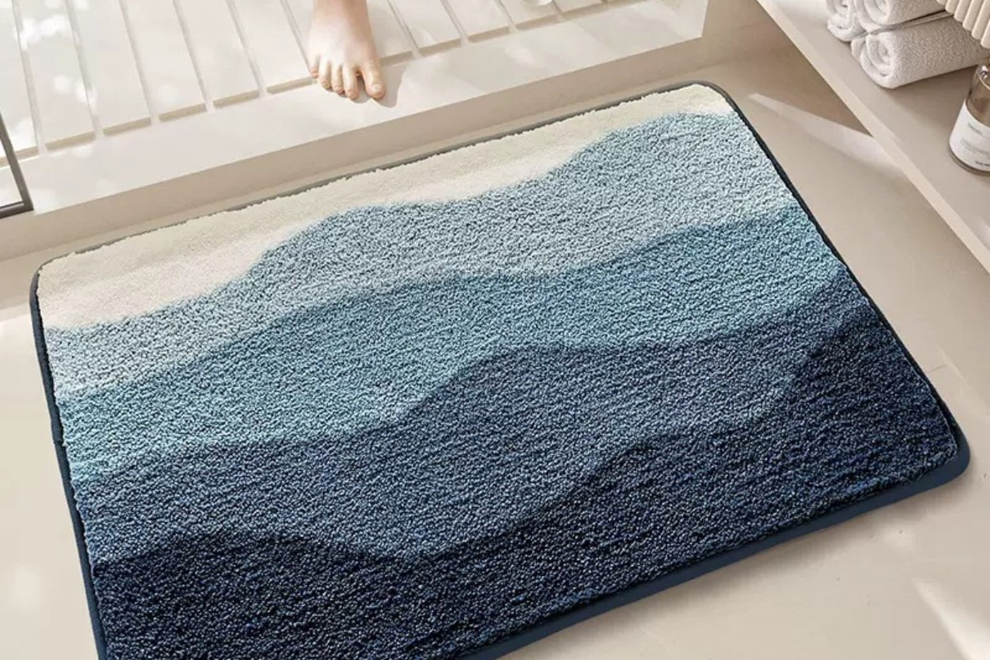 Indigo Tide Drift bath mat in layered blues