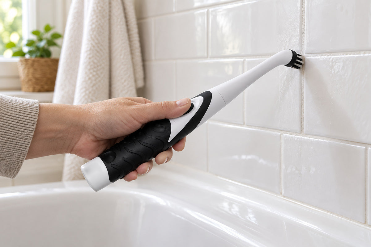 BrushEase cleaning a ceramic subway-tile grout line beside a bathtub