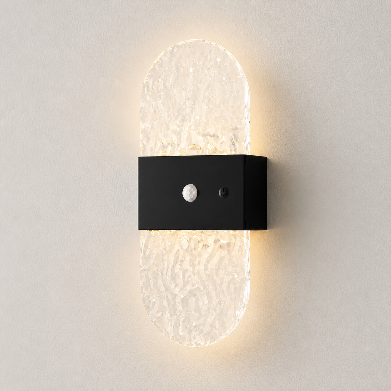 Facet Black Oval motion-sensor wall light on a warm-white wall