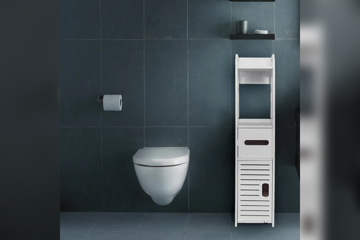 HavenTall slim white storage tower beside a toilet in a dark tiled bathroom