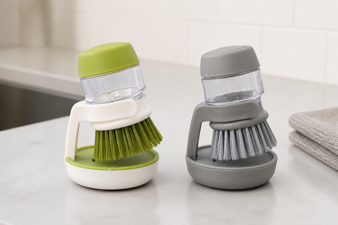 SudsNest soap-dispensing palm brushes in Sage Green and Grey